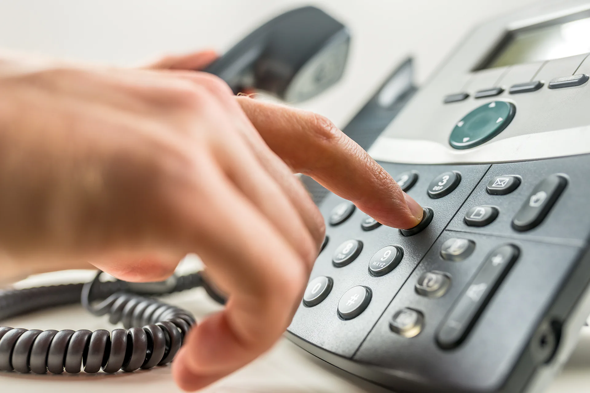 Woman dialing a phone